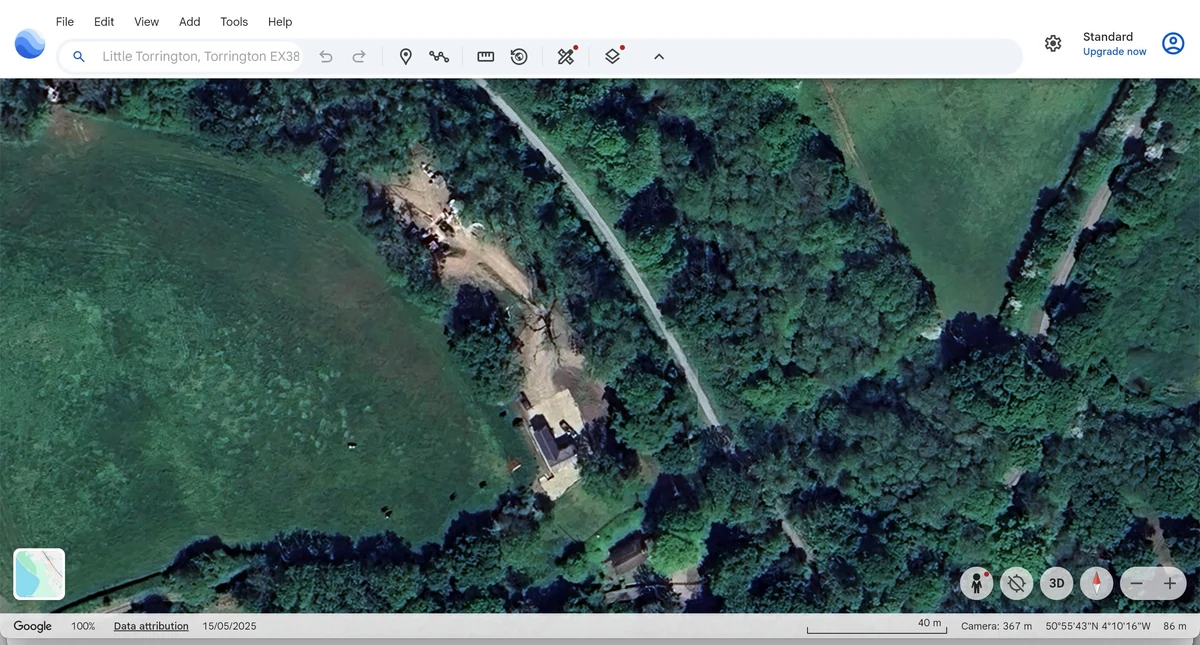 Google Earth aerial view dated 15 May 2025 of open ground, buildings, materials and neighbouring tree cover.