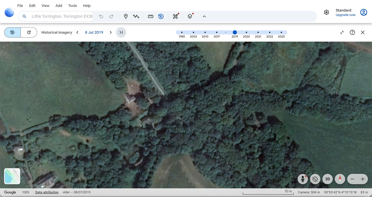 Google Earth historical aerial view dated 8 July 2019 of the buildings, adjoining wooded area and access routes.